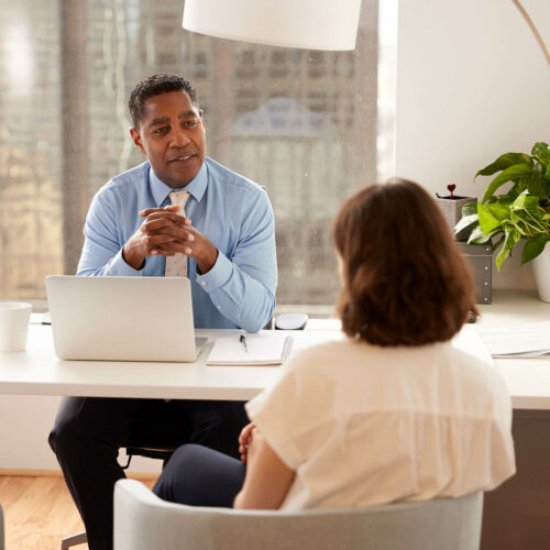 male-financial-advisor-in-modern-office-sitting-at-FTRMPA6